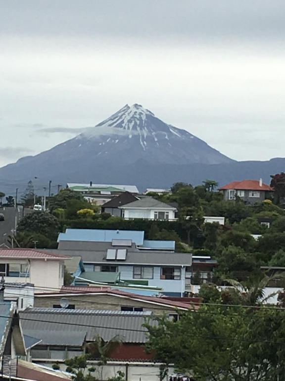a snow covered mountain in the background of a city at 4 Parris St in New Plymouth
