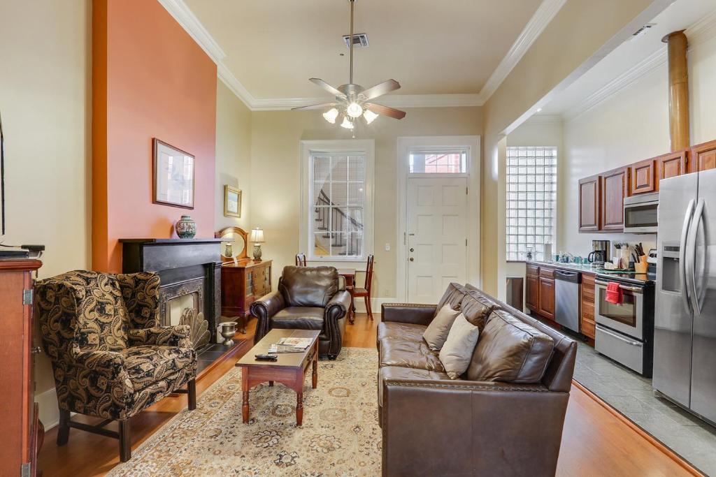 a living room with two couches and a kitchen at Grenoble House in New Orleans