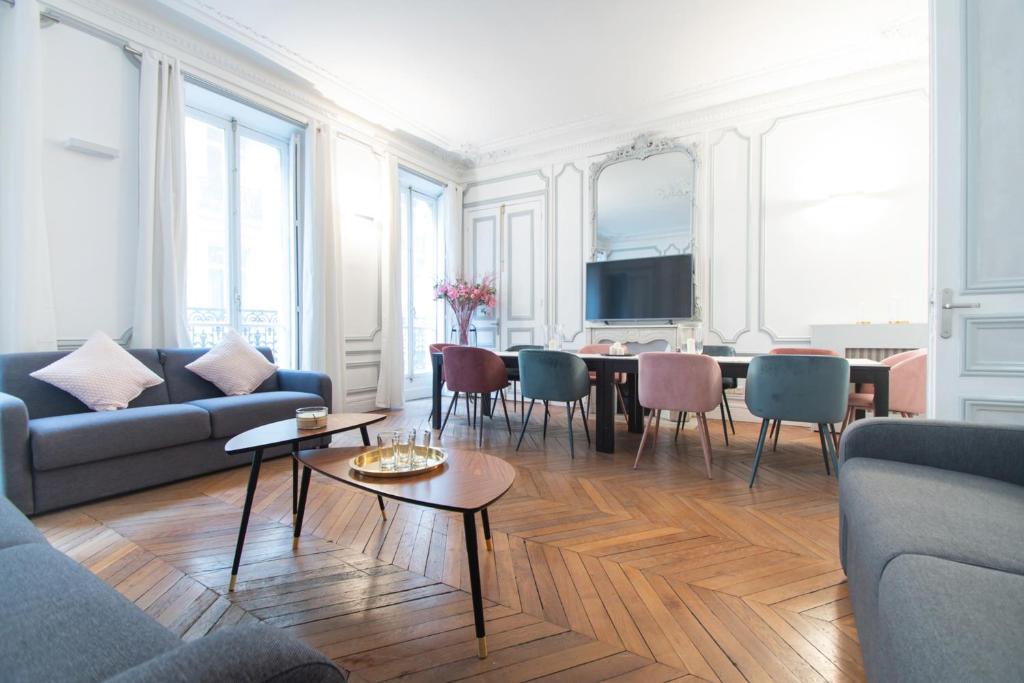 a living room with a couch and a table at Dreamyflat - Champs Élysées in Paris