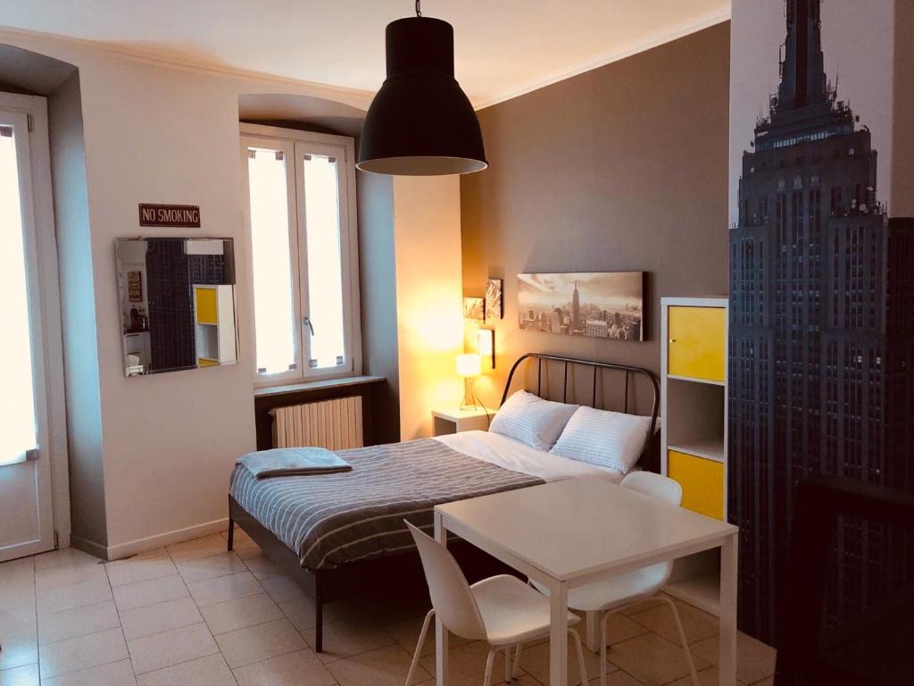 a bedroom with a bed and a table and a building at Al Centro Città in Bergamo