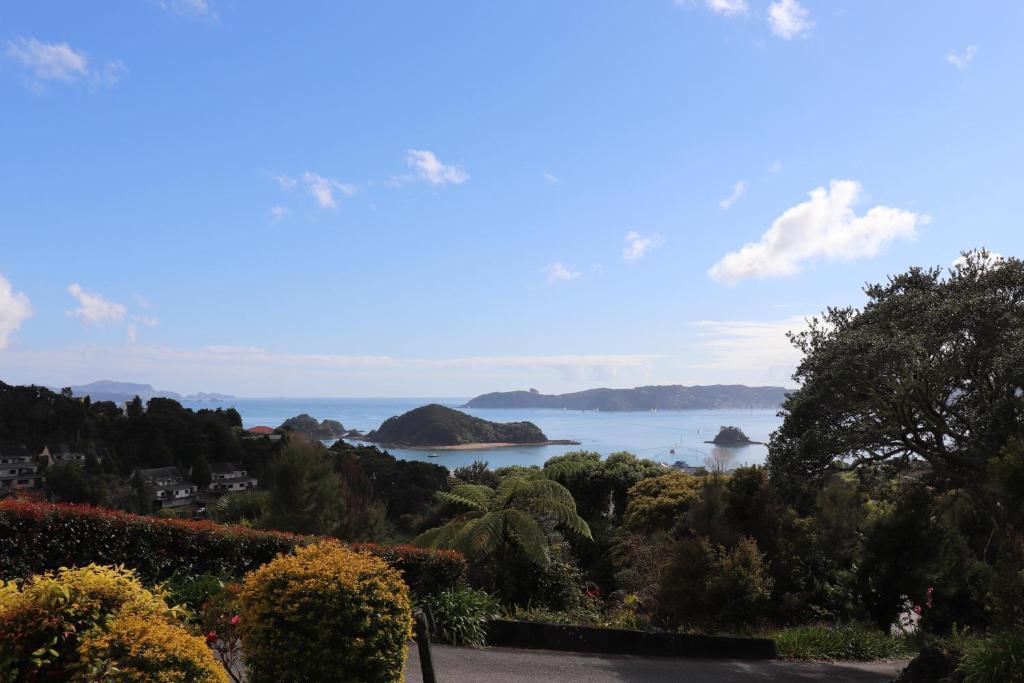 a view of the ocean from a garden at A Bay's Eye View in Paihia