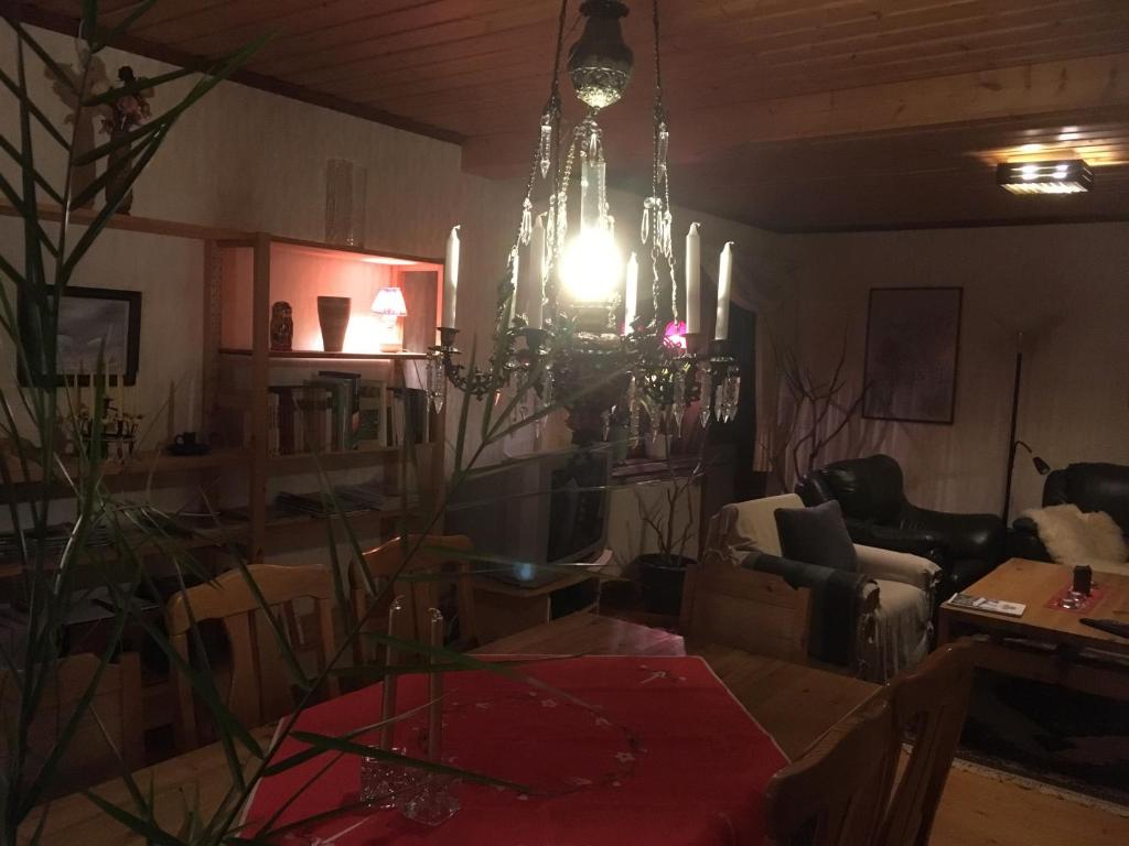 a living room with a chandelier hanging from the ceiling at Christinagården Guesthouse in Ramsele