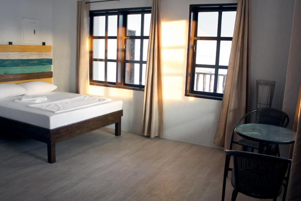 Postel nebo postele na pokoji v ubytování Sentro Suites Siargao