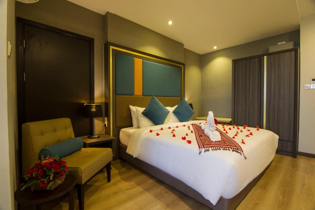 Postel nebo postele na pokoji v ubytování Goldenbay Hotel
