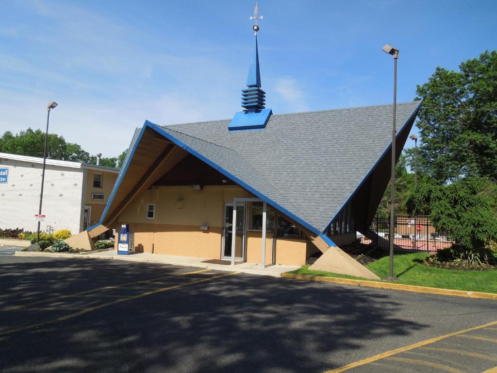 a building with a roof with a cross on top at Crystal Inn - Neptune in Neptune City