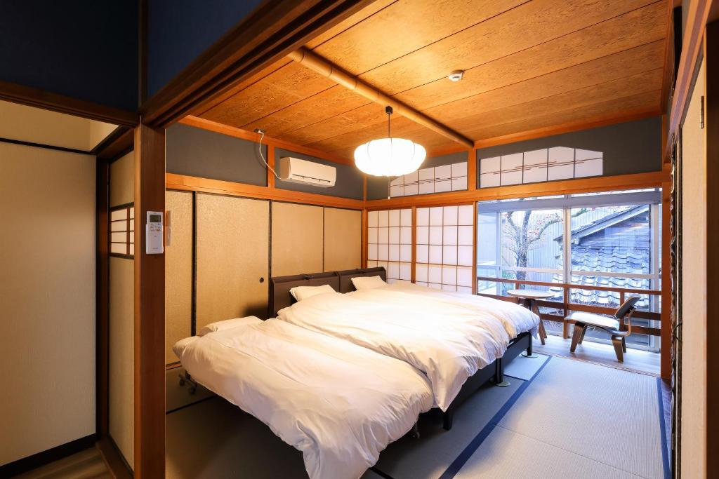 a bedroom with a large bed in a room at TAMACO in Kanazawa in Kanazawa