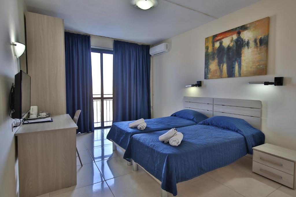 Postel nebo postele na pokoji v ubytování Relax Inn Hotel