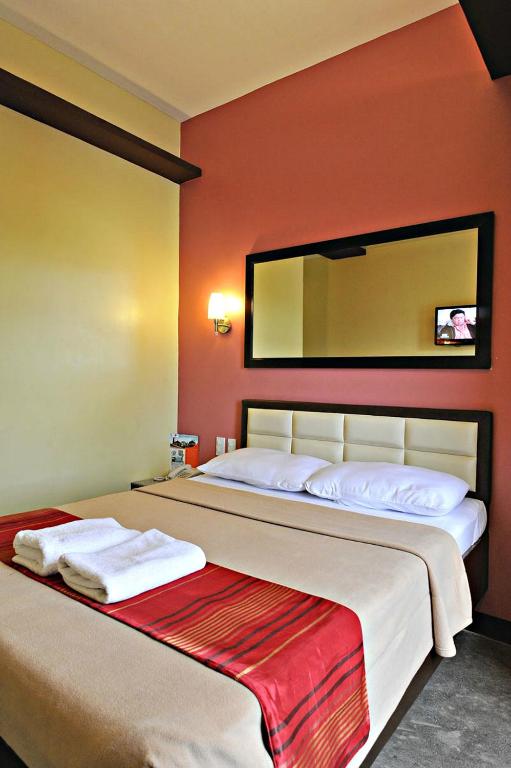 Postel nebo postele na pokoji v ubytování Express Inn Cebu Mabolo