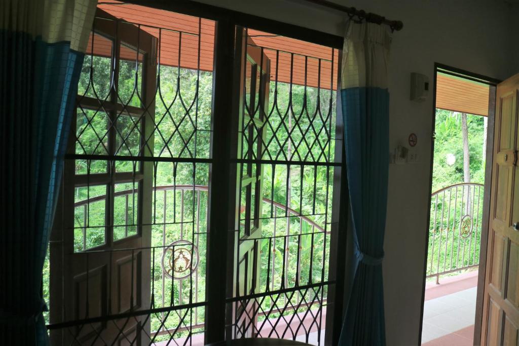an open window looking out onto a garden at Grand View in Patong Beach