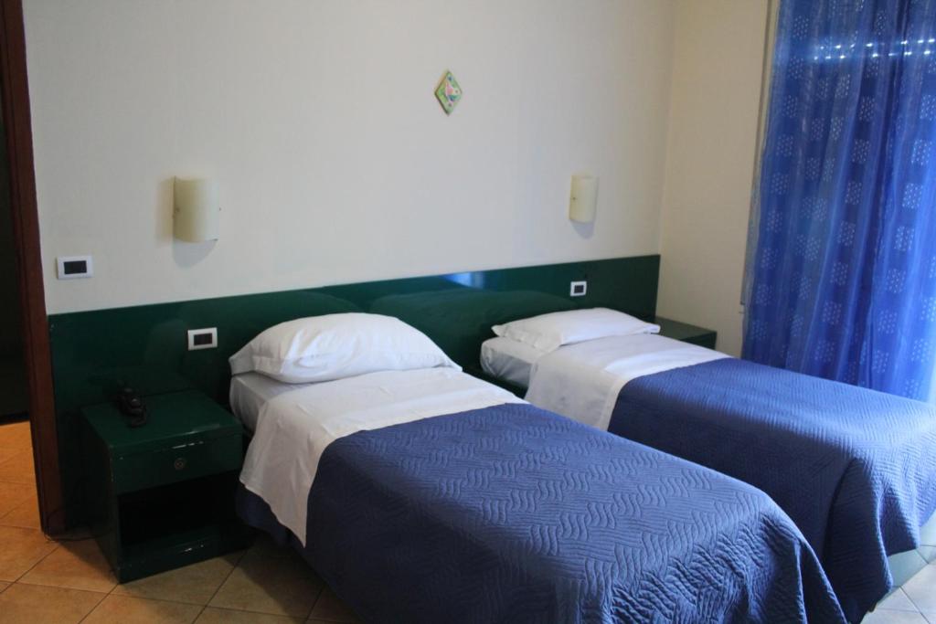 Postel nebo postele na pokoji v ubytování Hotel 106