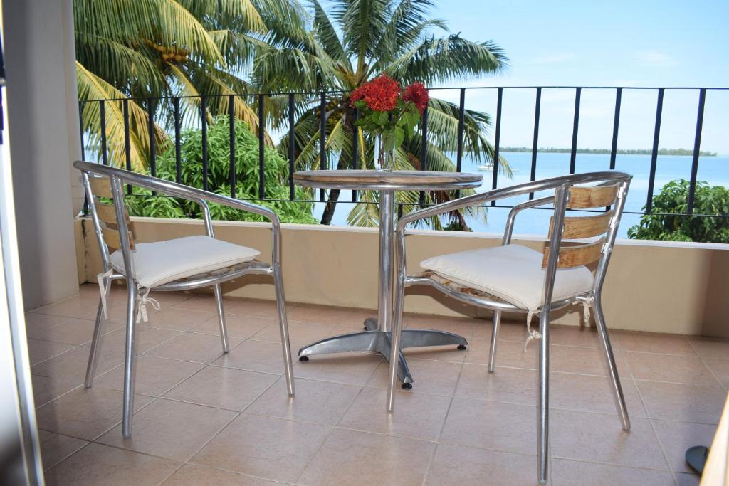 two chairs and a table on a balcony with the ocean at Seaview Kite Studio - La Gaulette in La Gaulette