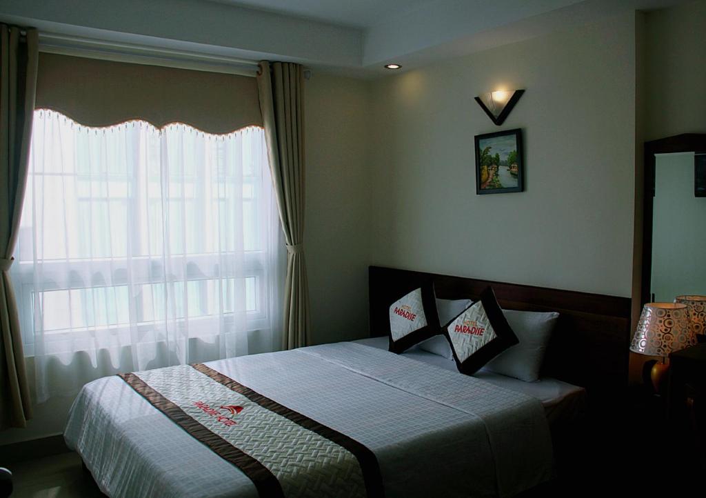 Postel nebo postele na pokoji v ubytování Paradise Hotel
