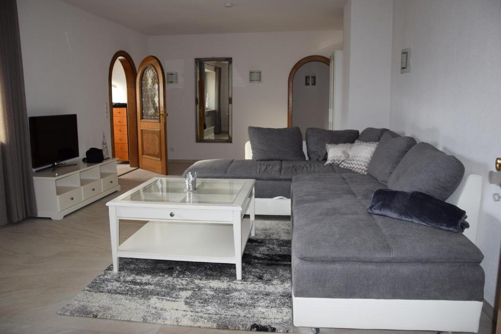 a living room with a couch and a coffee table at FEWO-Horgau in Horgau