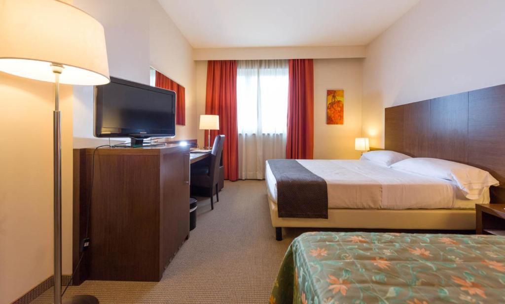 Postel nebo postele na pokoji v ubytování Torino Hotel San Luigi - Ristorante Trait d'Union