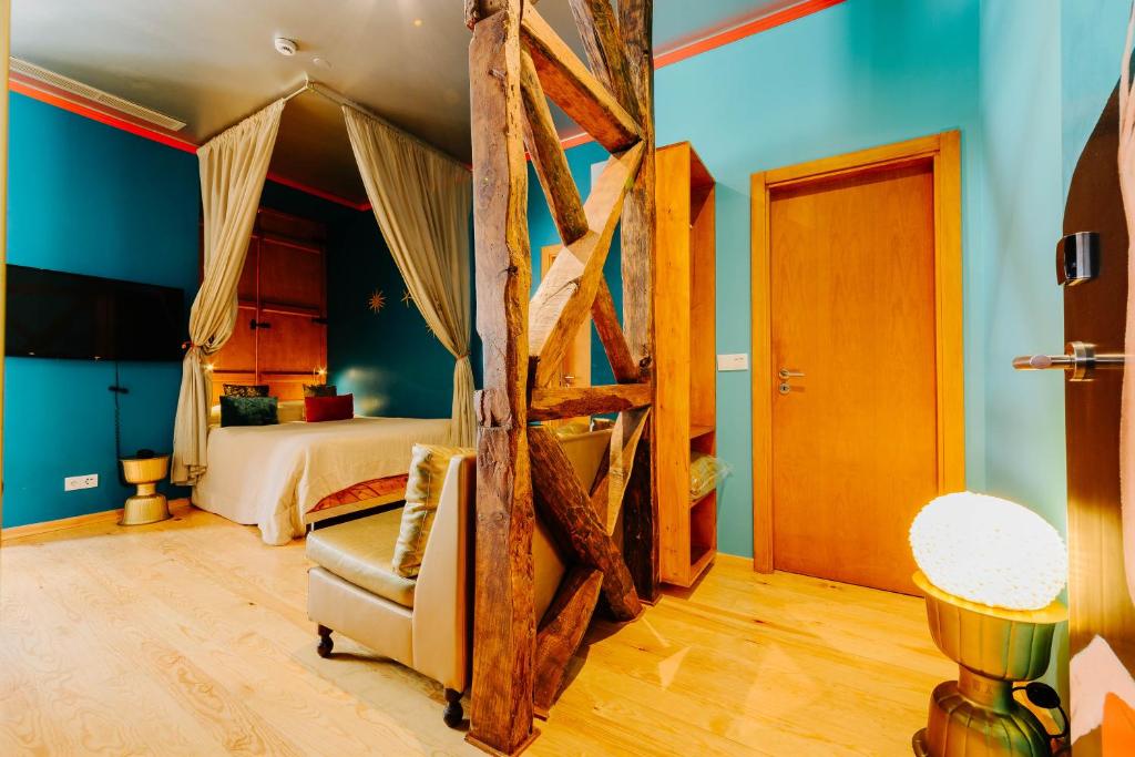 a living room with a wooden floor and a wooden bed at Lisbon Art Stay Apartments Baixa in Lisbon