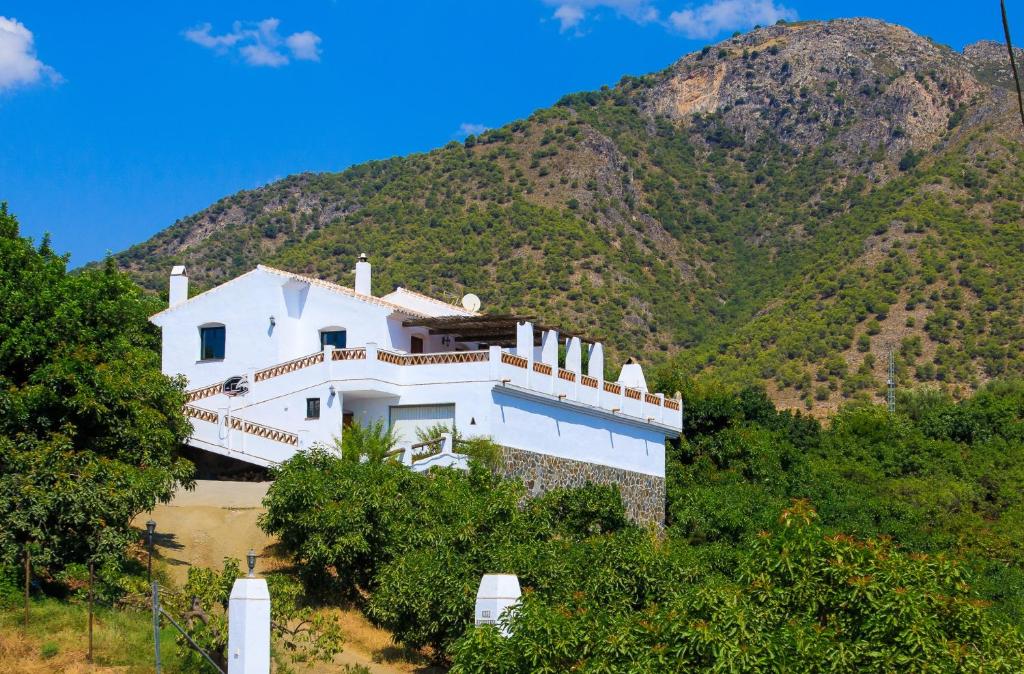 a white house on top of a mountain at Cortijo Los Madroños in Frigiliana