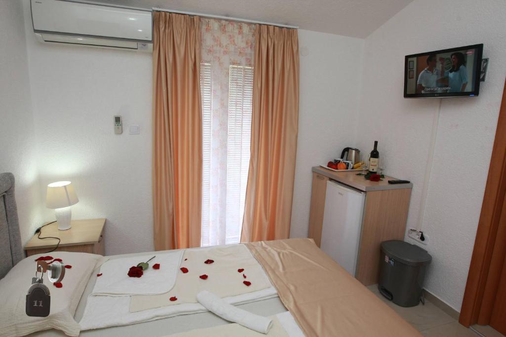 a bedroom with a bed with roses on it at Villa Andjelina in Budva