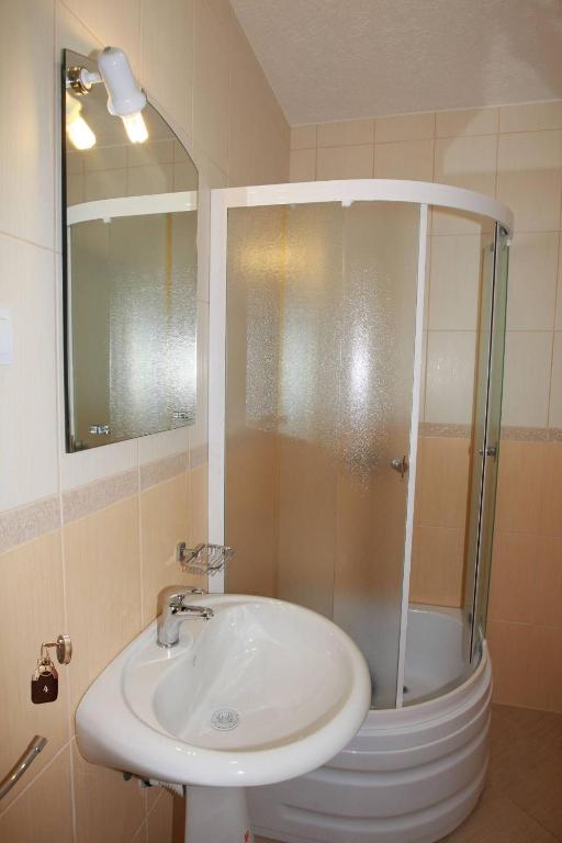 a bathroom with a sink and a shower at Villa Andjelina in Budva