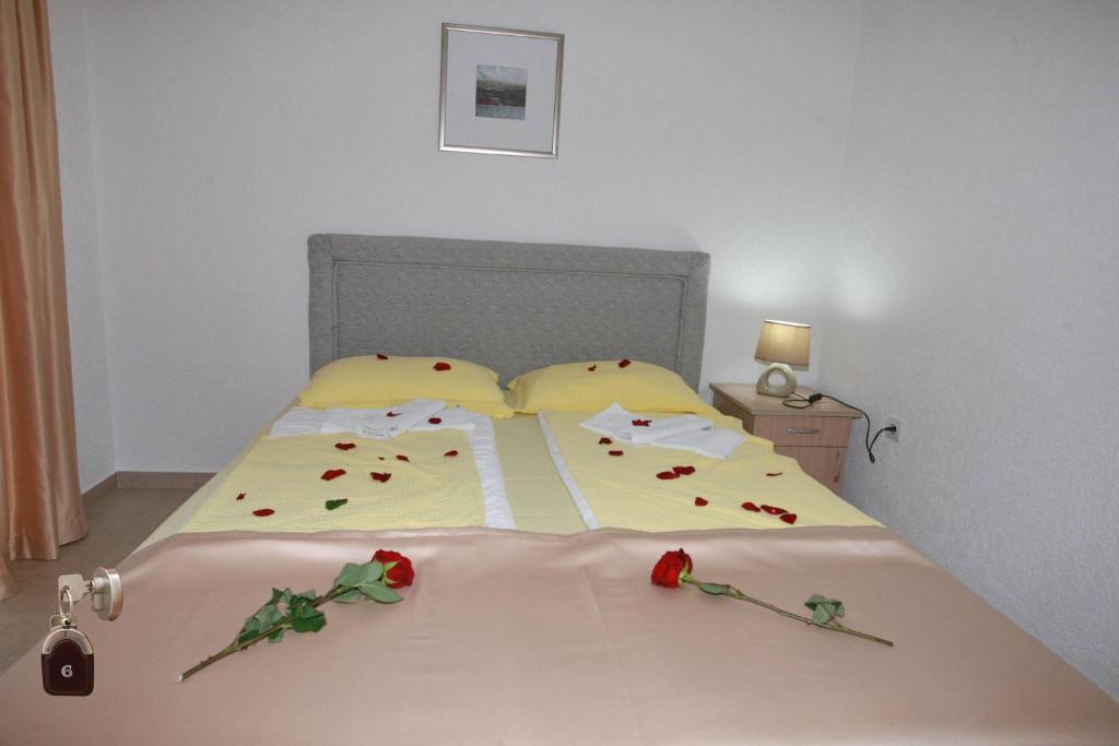 a bedroom with a bed with roses on it at Villa Andjelina in Budva
