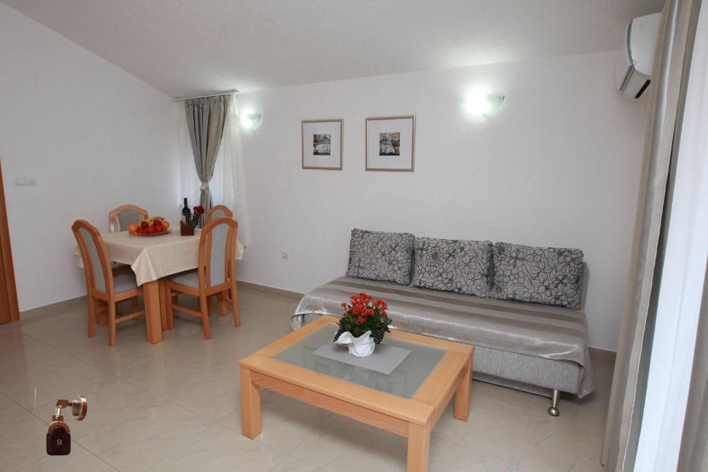 a living room with a couch and a table at Villa Andjelina in Budva