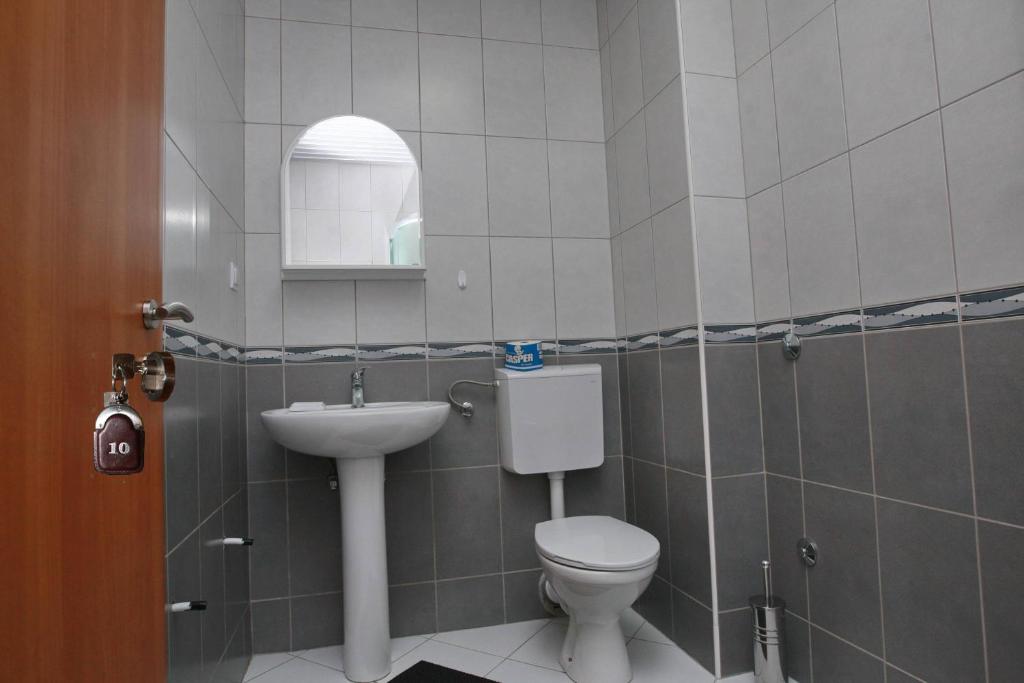 a bathroom with a toilet and a sink at Villa Andjelina in Budva