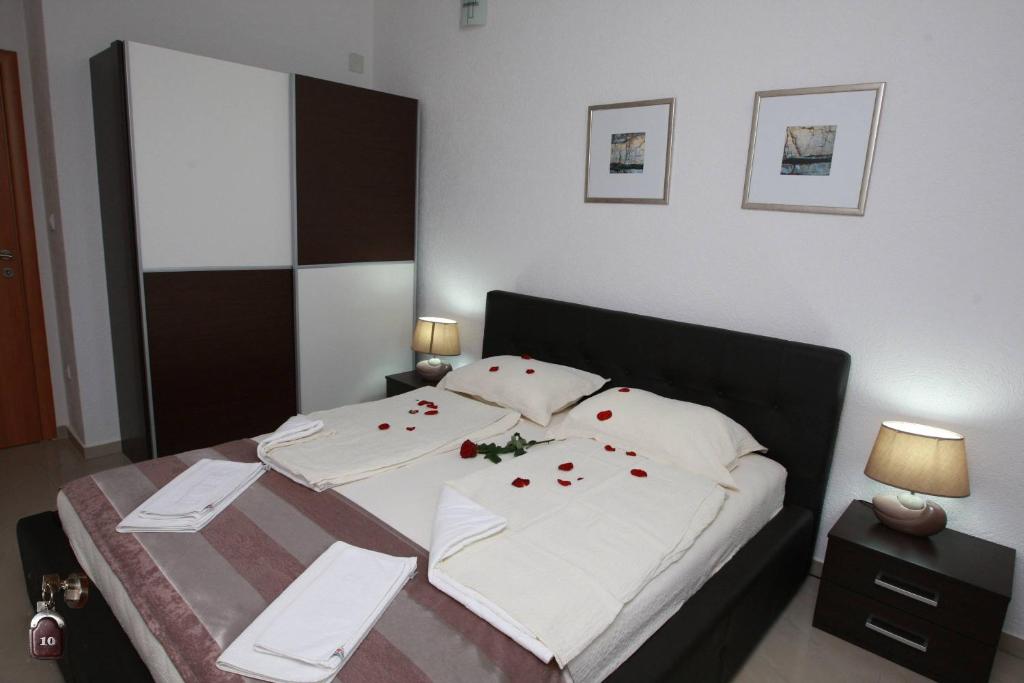 a bedroom with a bed with red roses on it at Villa Andjelina in Budva