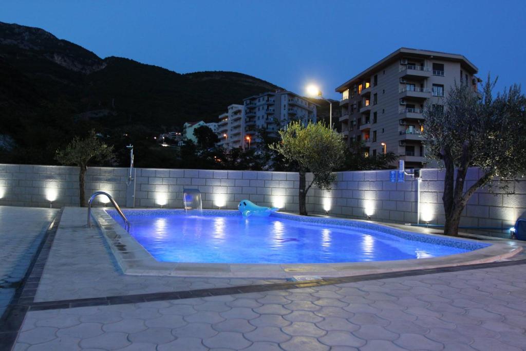 a swimming pool in a city at night at Villa Andjelina in Budva