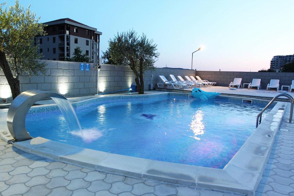 a large swimming pool with a water slide at Villa Andjelina in Budva