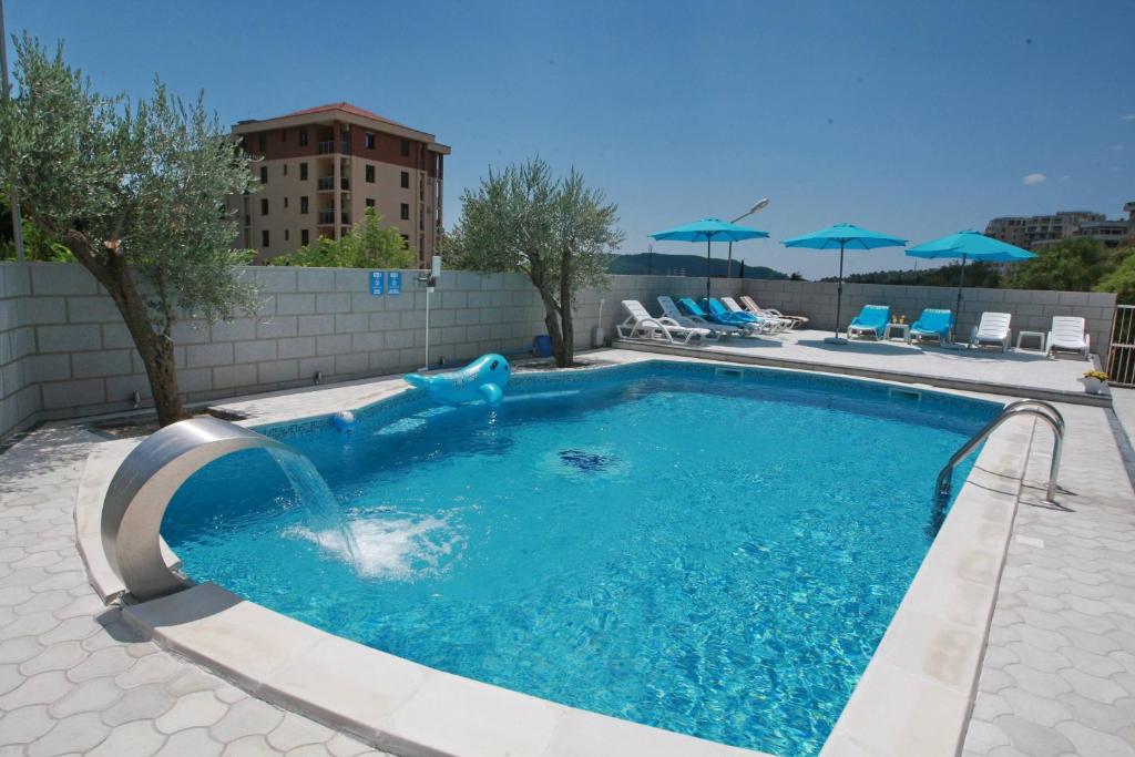 a swimming pool with a dolphin in the middle at Villa Andjelina in Budva