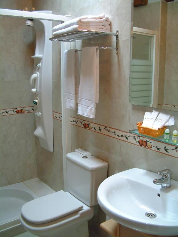 a bathroom with a toilet and a sink at Hotel Aldama Golf in Quintana de Llanes