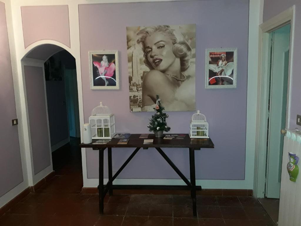 un tavolo con un albero di Natale su un muro con delle foto di La Mansarda di Marilyn in Toscana a Cetona