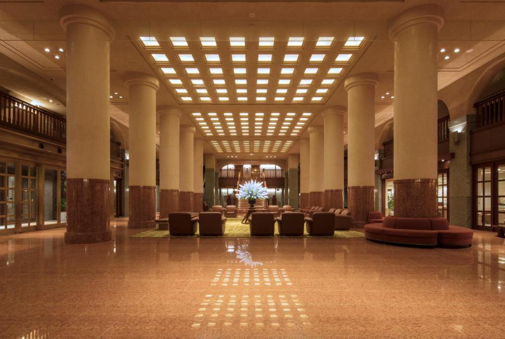 a large lobby with chairs and a large ceiling at Hotel Okura Kyoto in Kyoto