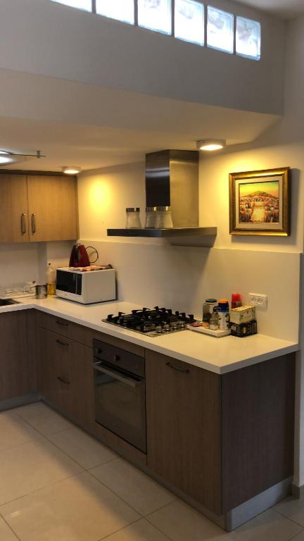 a kitchen with a stove and a counter top at 29 Efraim Street Apartment in Modi'in