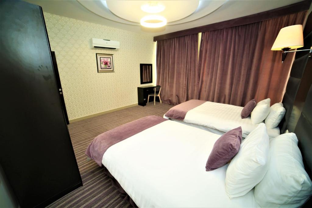 Postel nebo postele na pokoji v ubytování Al Dyafa Hotel Suites