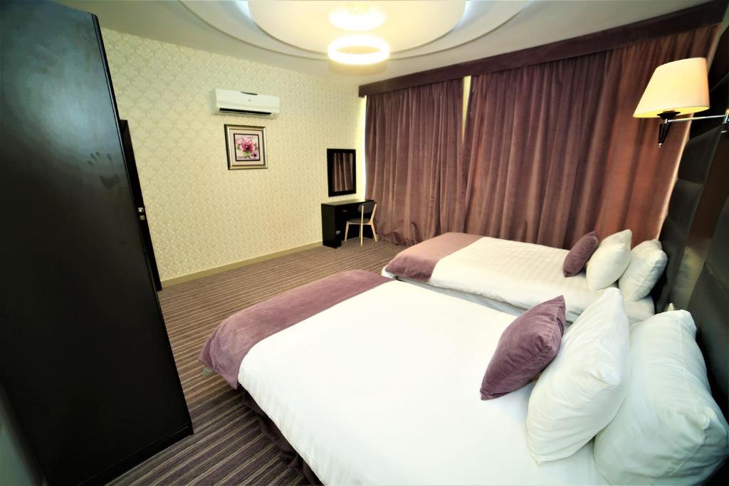 เตียงในห้องที่ Al Dyafa Hotel Suites
