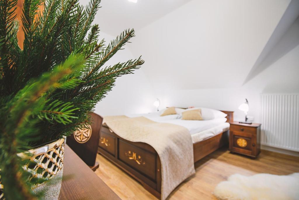a bedroom with a bed and a christmas tree at Willa 35 in Leśnica
