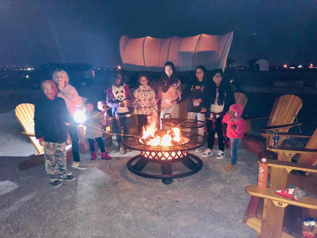 a group of people standing around a fire pit at Orr Family Farm & RR, LLC in Oklahoma City