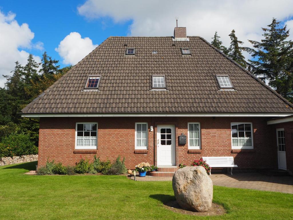 ein rotes Backsteinhaus mit einem Dach in der Unterkunft Suite in Nieblum - Martina Christiansen in Nieblum