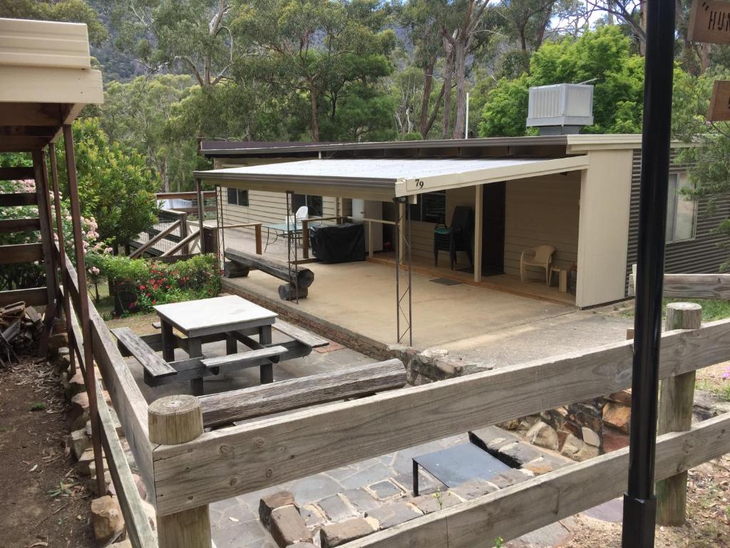 a house with a porch and a picnic table at Huntinaddi Lodge in Halls Gap