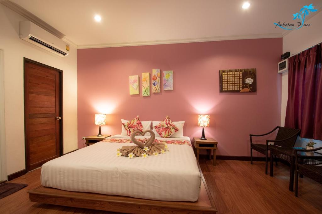 a bedroom with a bed with a stuffed animal on it at Aukotan Place in Koh Tao