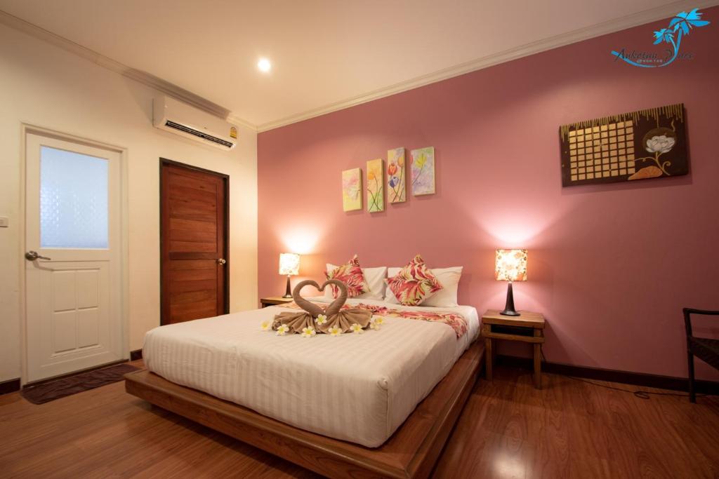 a bedroom with a bed with a animal on it at Aukotan Place in Koh Tao