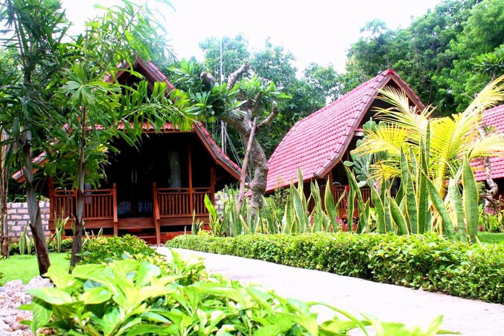 a house with a red roof in a garden at Beautiful house in Nusa Penida