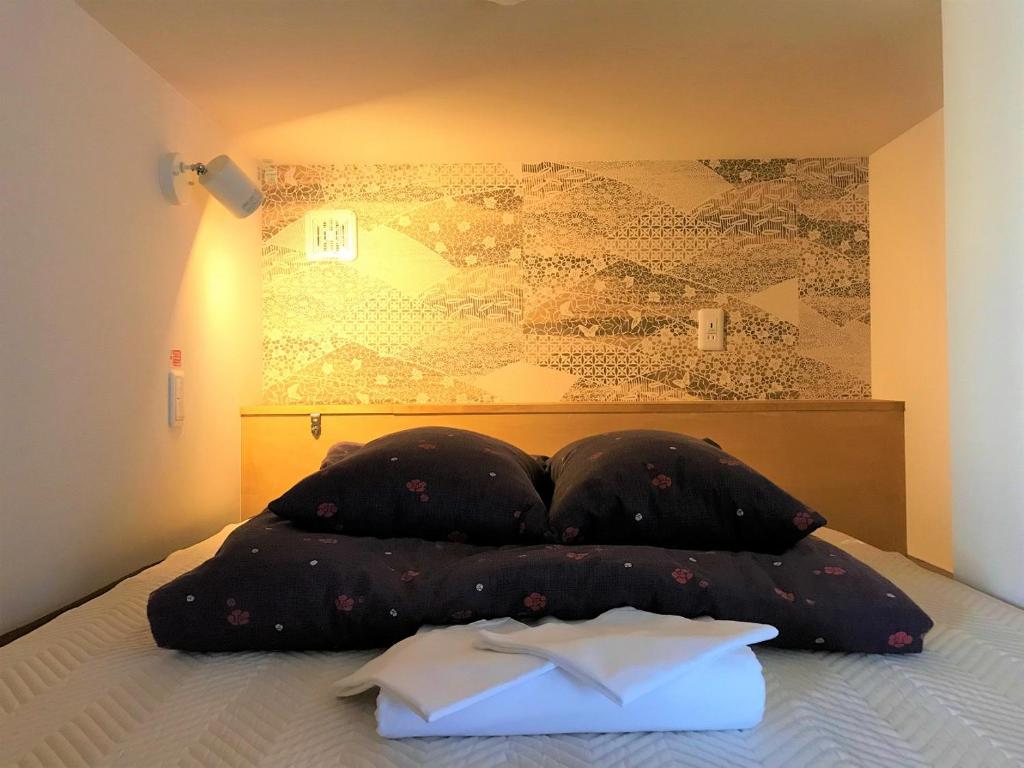 Postel nebo postele na pokoji v ubytování K's House Kanazawa - Travelers Hostel