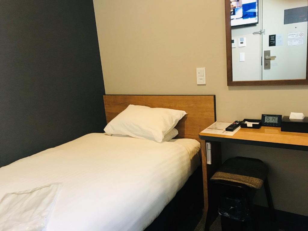 Postel nebo postele na pokoji v ubytování Kamon Hotel Seto