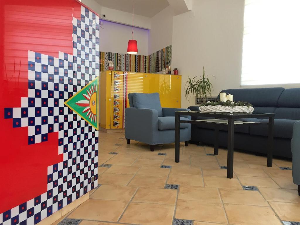 a living room with a table and chairs at Petruso Resort in Balestrate
