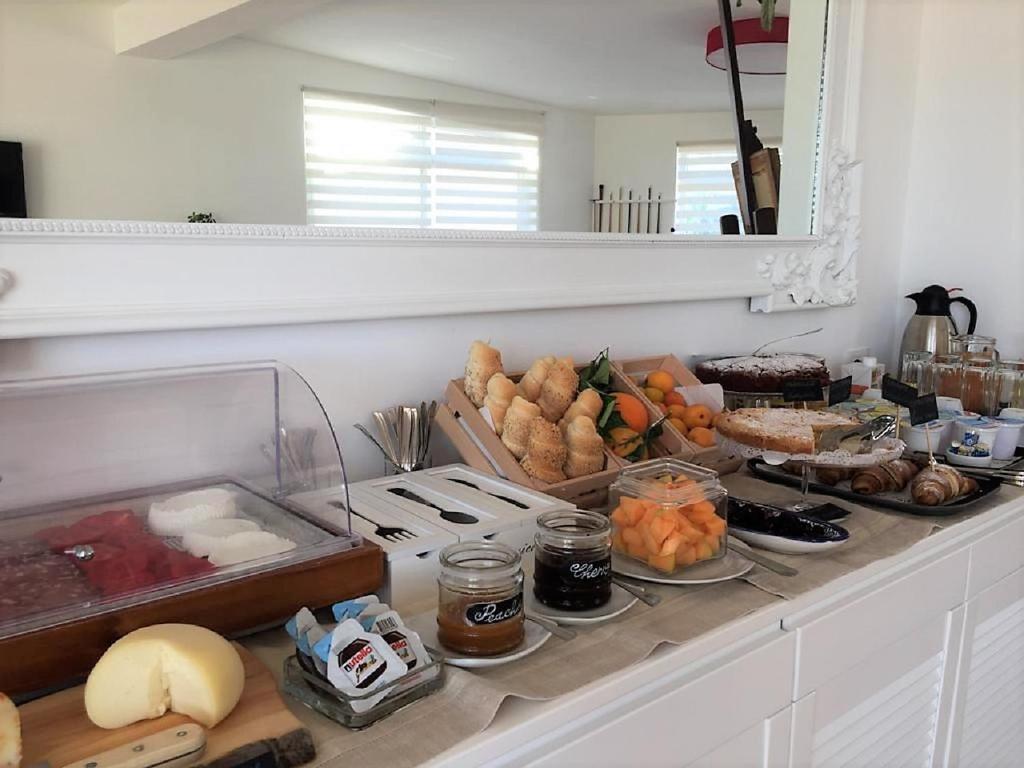 a kitchen counter with a bunch of food on it at Petruso Resort in Balestrate