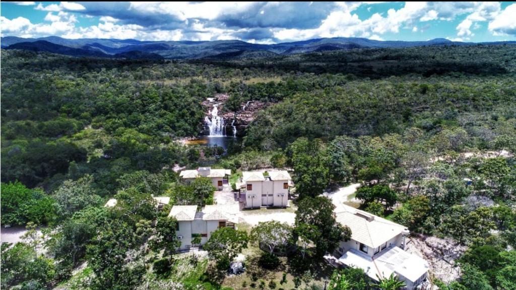 - une vue aérienne sur une maison avec une cascade dans l'établissement Pousada Cachoeira Poço Encantado, à Alto Paraíso de Goiás