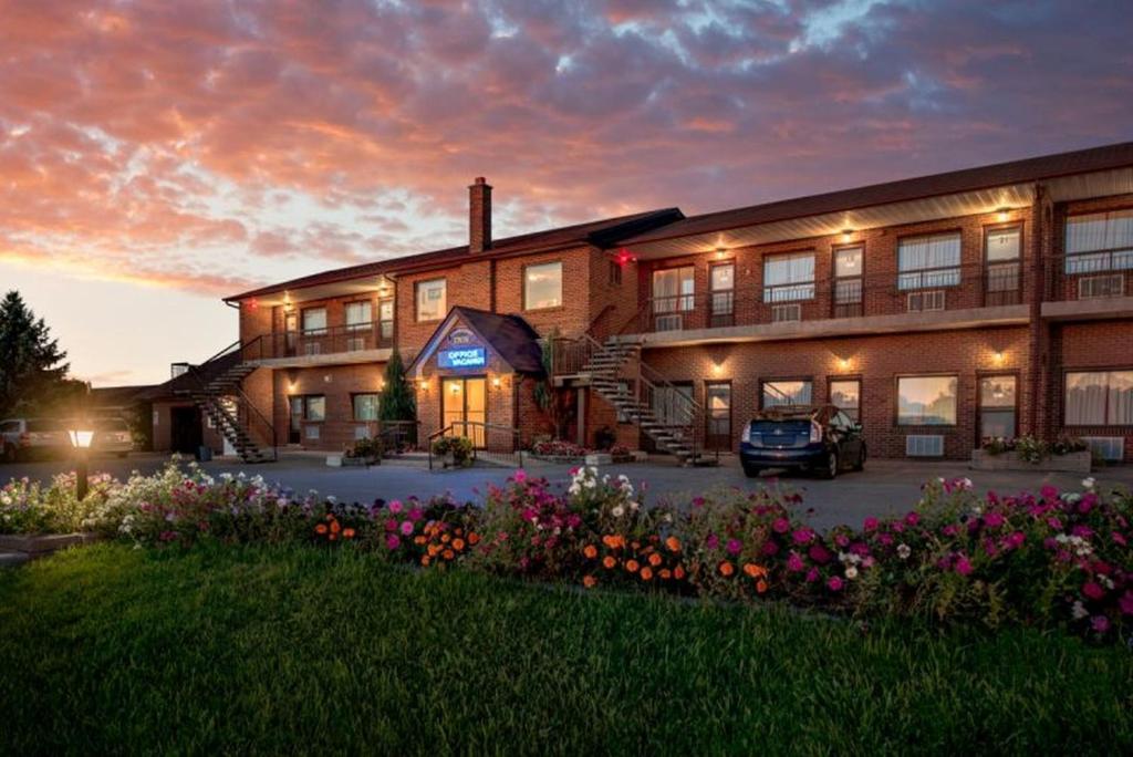 a building with a car parked in front of it at Newmarket Inn in Newmarket