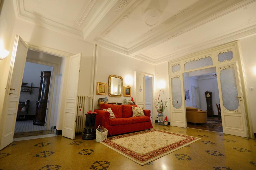 a living room with a red couch in a building at " La Casa di Lella " in Genoa