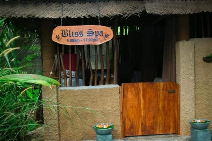 a sign on the side of a building with a wooden door at Selnara Private Luxury Villa and Ayurveda Spa in Bentota